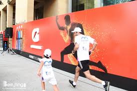 Runner of the future keeping up with his old man at a Gatorade sponsored marathon.